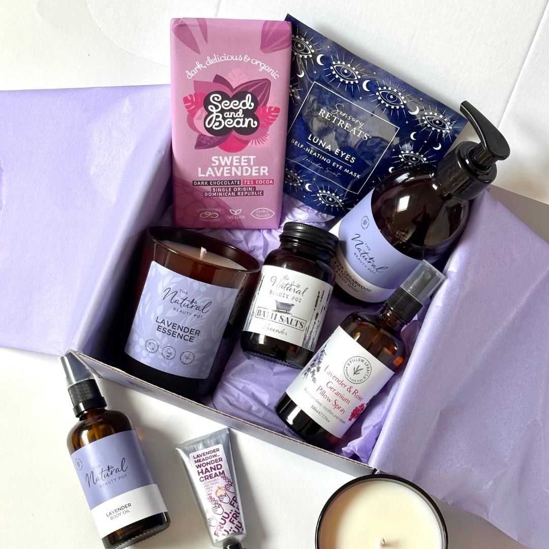 Corporate Gifting for clients and employees a box with wellbeing items natural candle, hand wash, bath salts, vegan chocolate, hand cream, eye mask, pillow spray