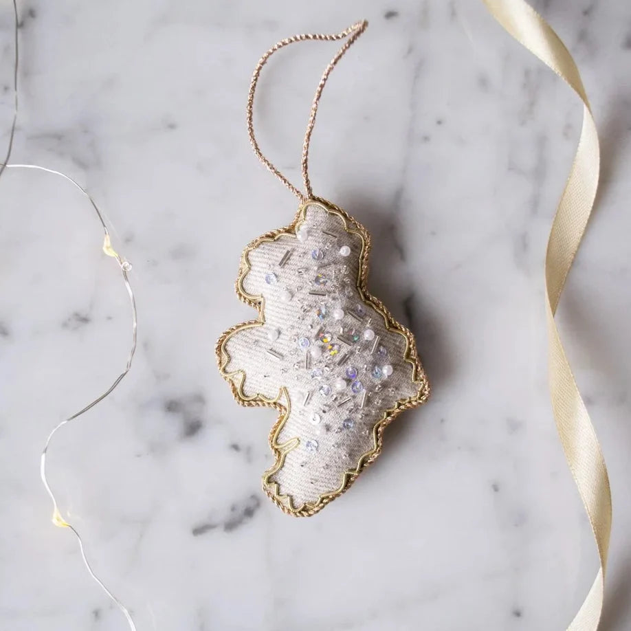 Decorative ornament with gold rim on a marble surface with string lights