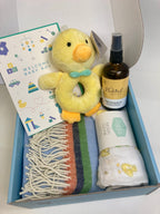 Baby boy gift box with natural and organic massage oil, plush duck, bottle, and blue Mcnutt blanket 
