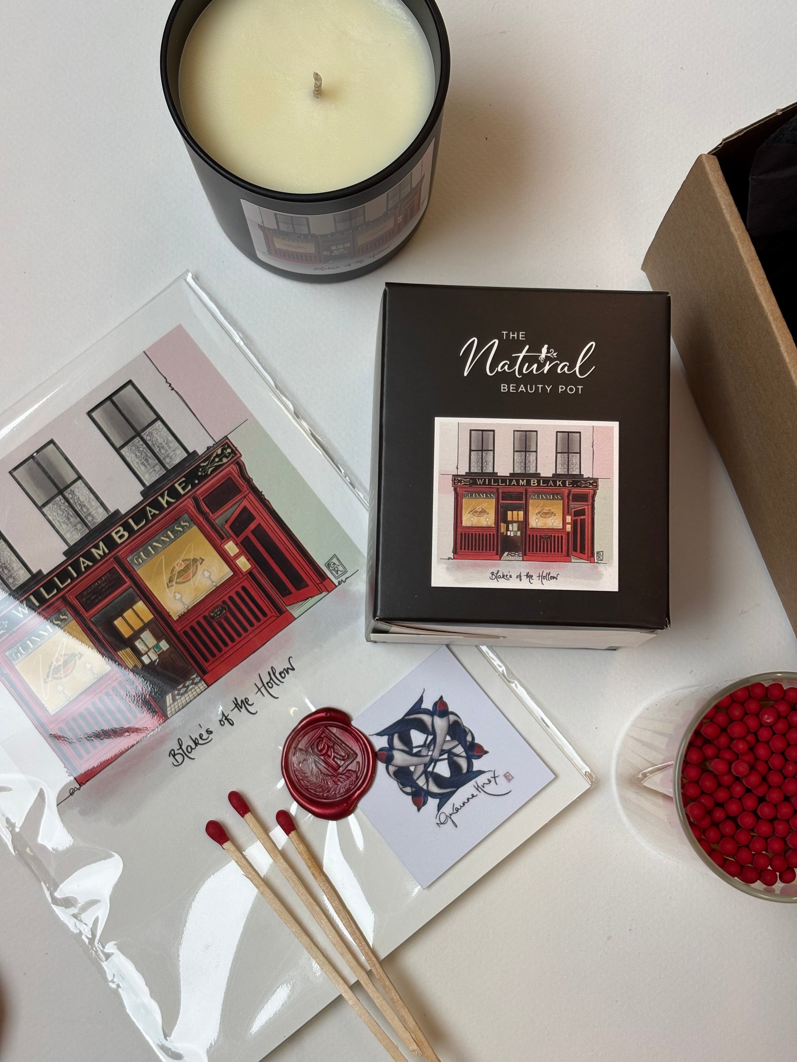 Blakes of the Hollow Enniskillen print by Grainne Know, candle by the Natural Beauty Pot, red tipped matches in glass bottle with cork