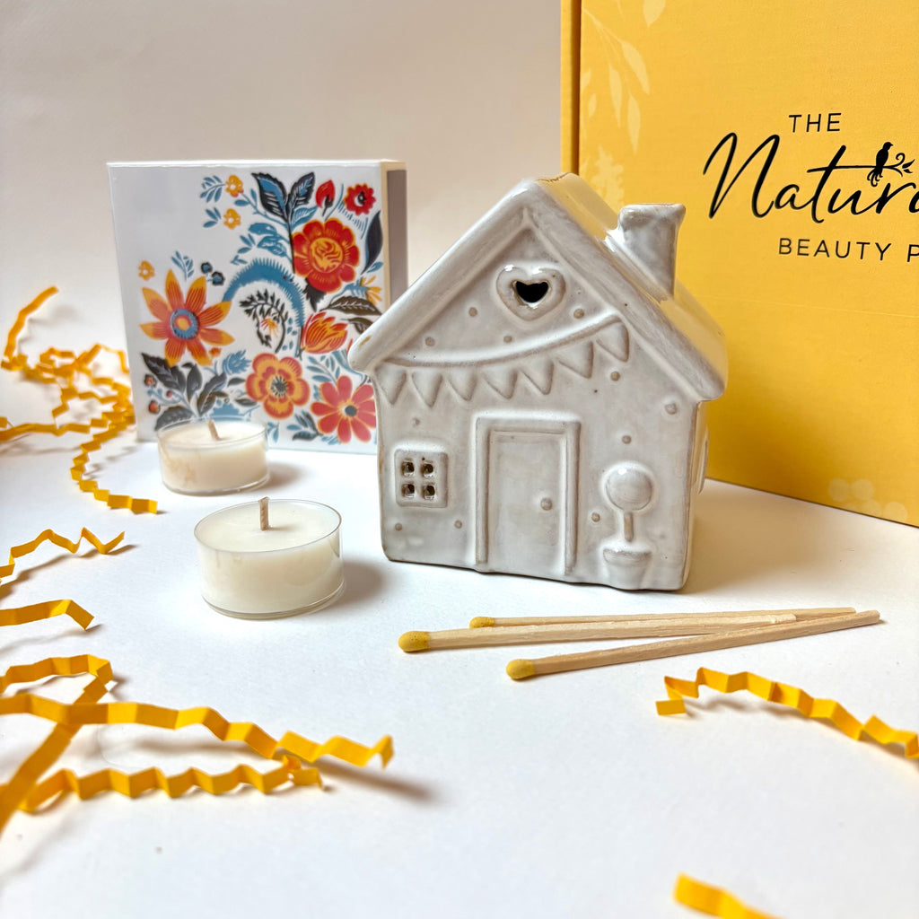Ceramic house-shaped candle holder with candles and a decorative box The Natural Beauty Pot