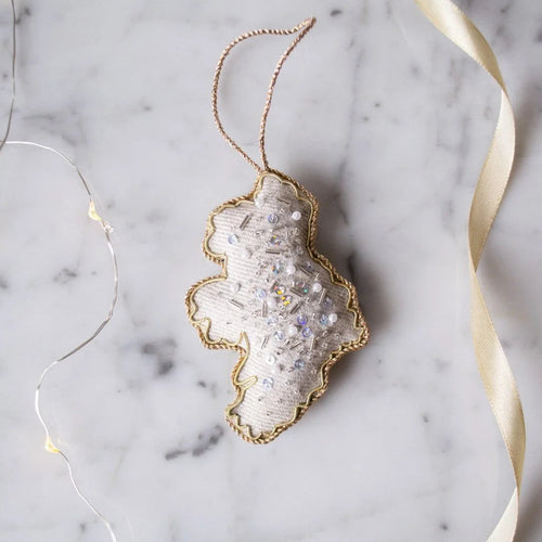 Decorative ornament with gold rim on a marble surface with string lights