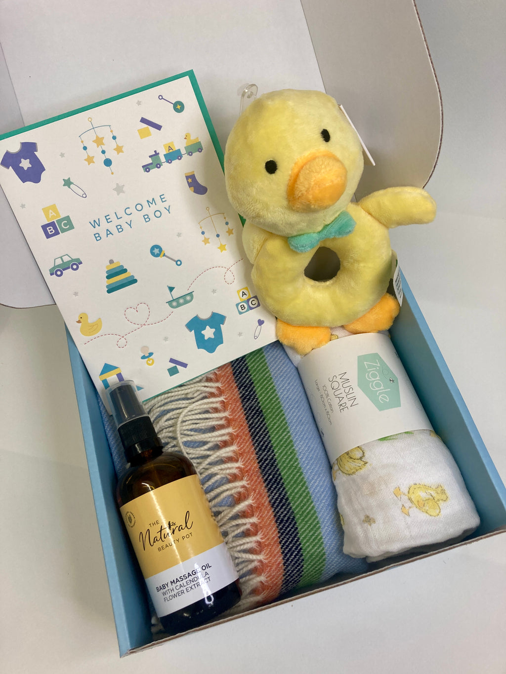 Luxury new baby boy gift Mcnutt of donegal baby blanket, natural and organic baby massage oil, large cotton muslin, plush duck rattle, letterpressed card by the Natural Beauty Pot