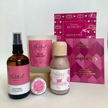 Collection of skincare products with pink and white packaging on a white background
