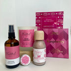Collection of natural beauty products with pink packaging on a white background