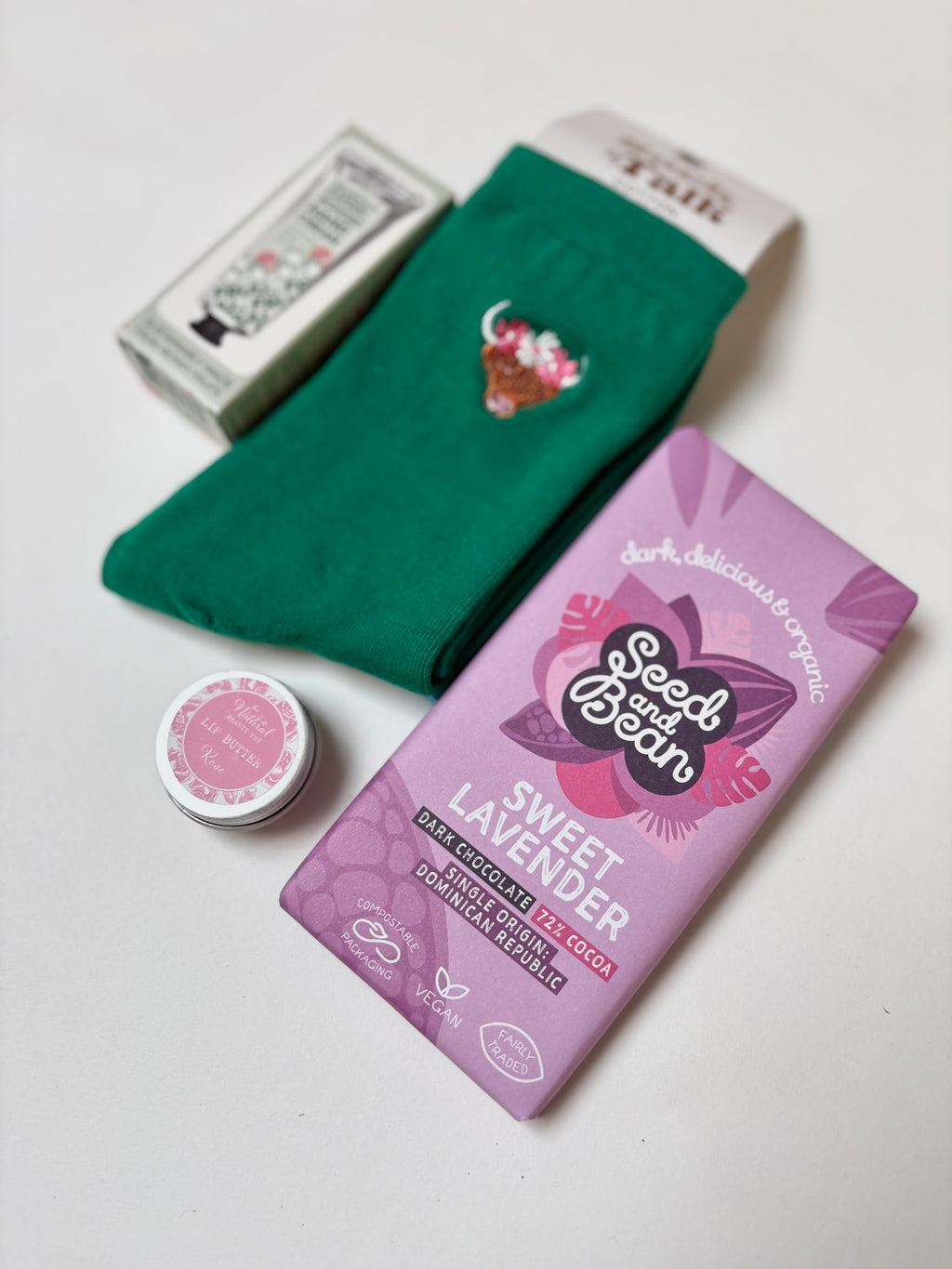 thoughtful self care gift highland cow socks, grapefruit hand cream, sweet lavender vegan chocolate, natural organic lip butter
