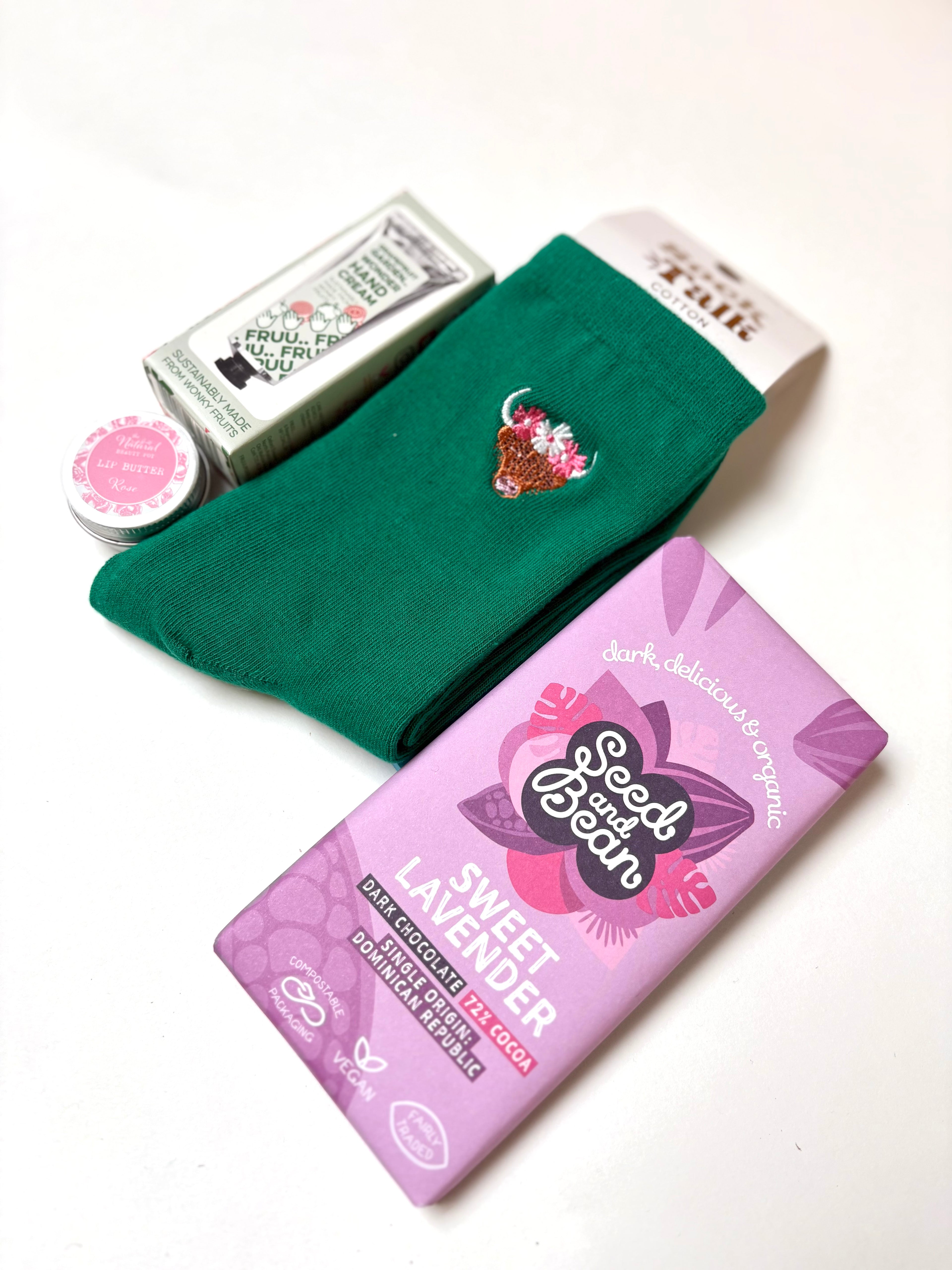 thoughtful self care gift highland cow socks, grapefruit hand cream, sweet lavender vegan chocolate, organic lip butter