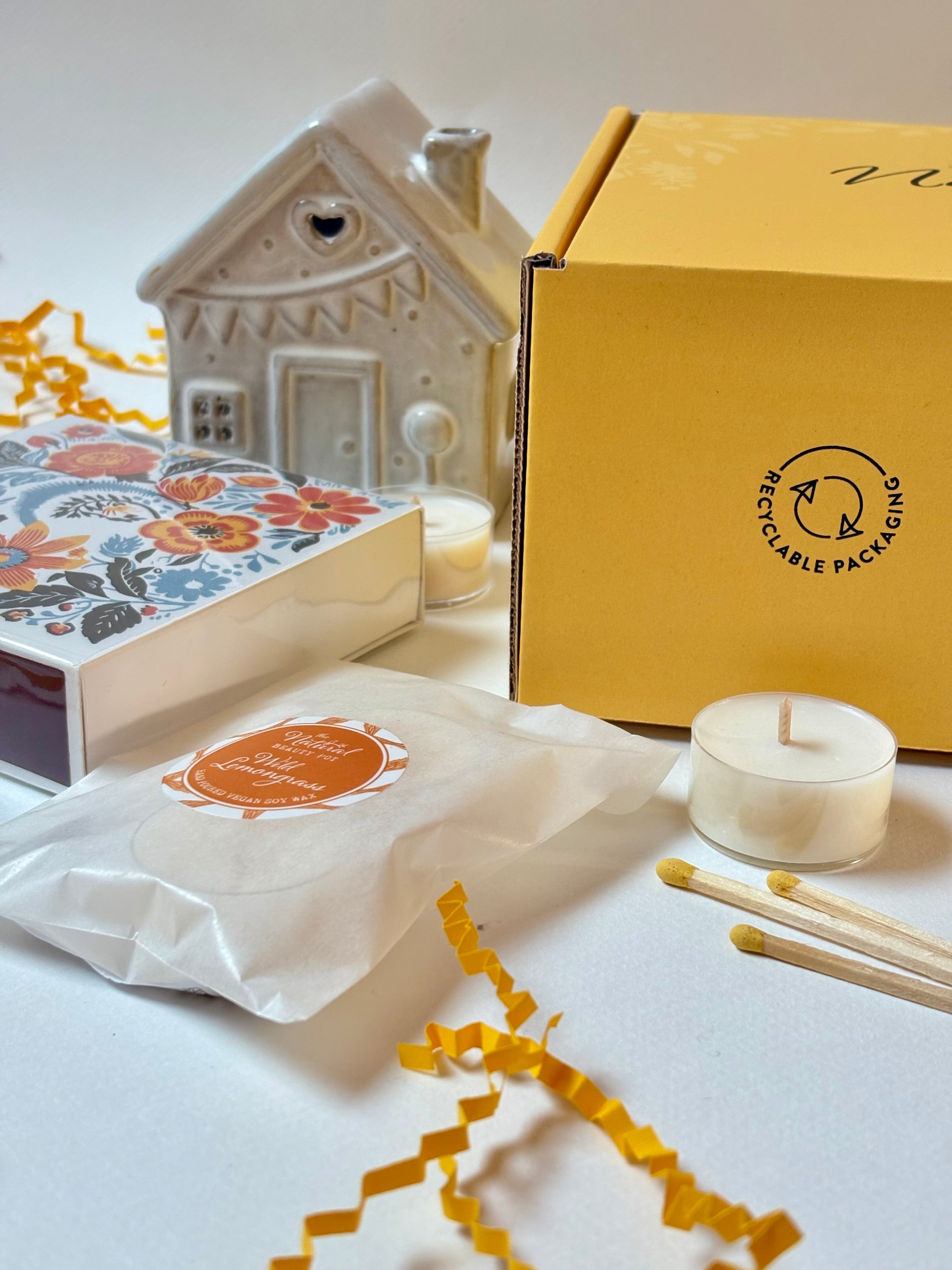  yellow gift box, ceramic tea light house, matches and candles 