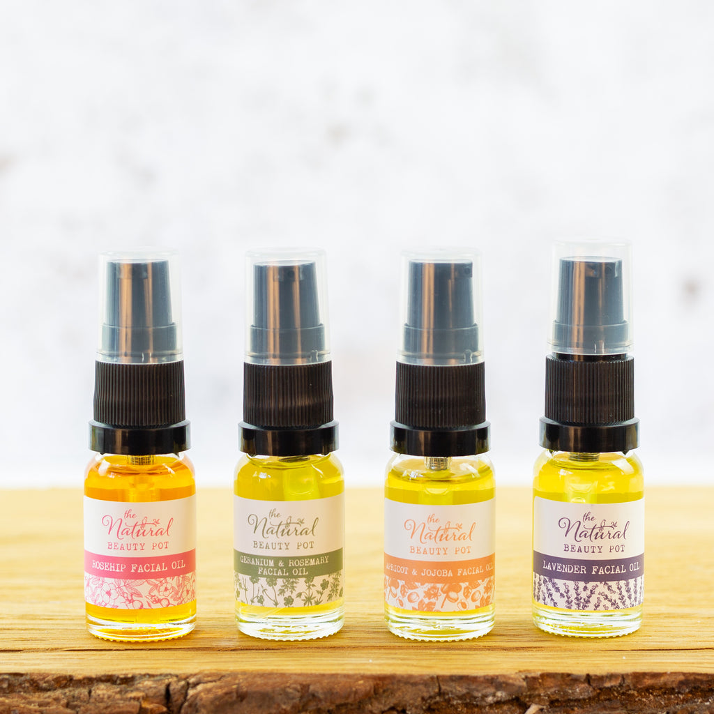 Four small bottles of facial oil with, each made with natural and organic ingredients