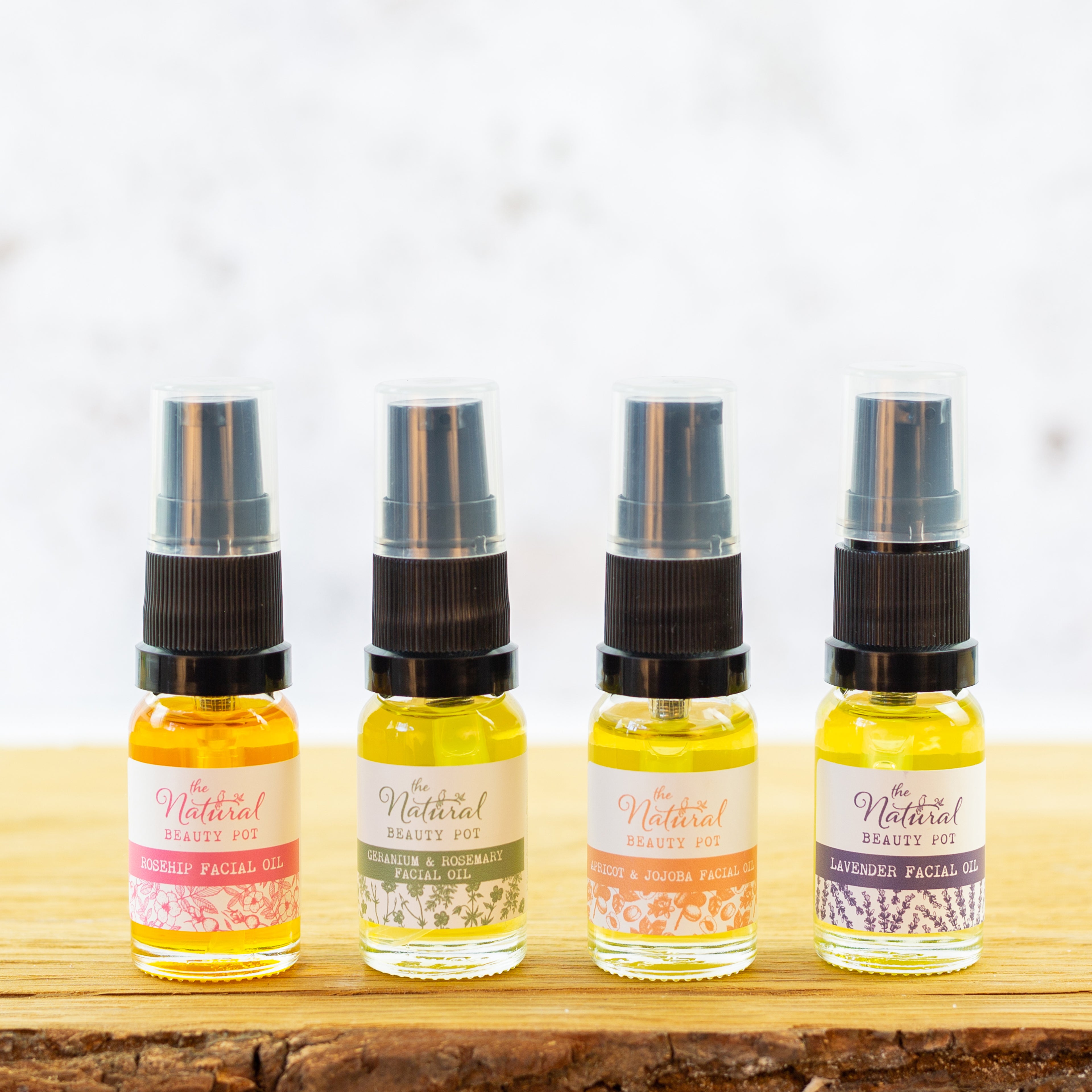 Four small bottles of facial oil with, each made with natural and organic ingredients